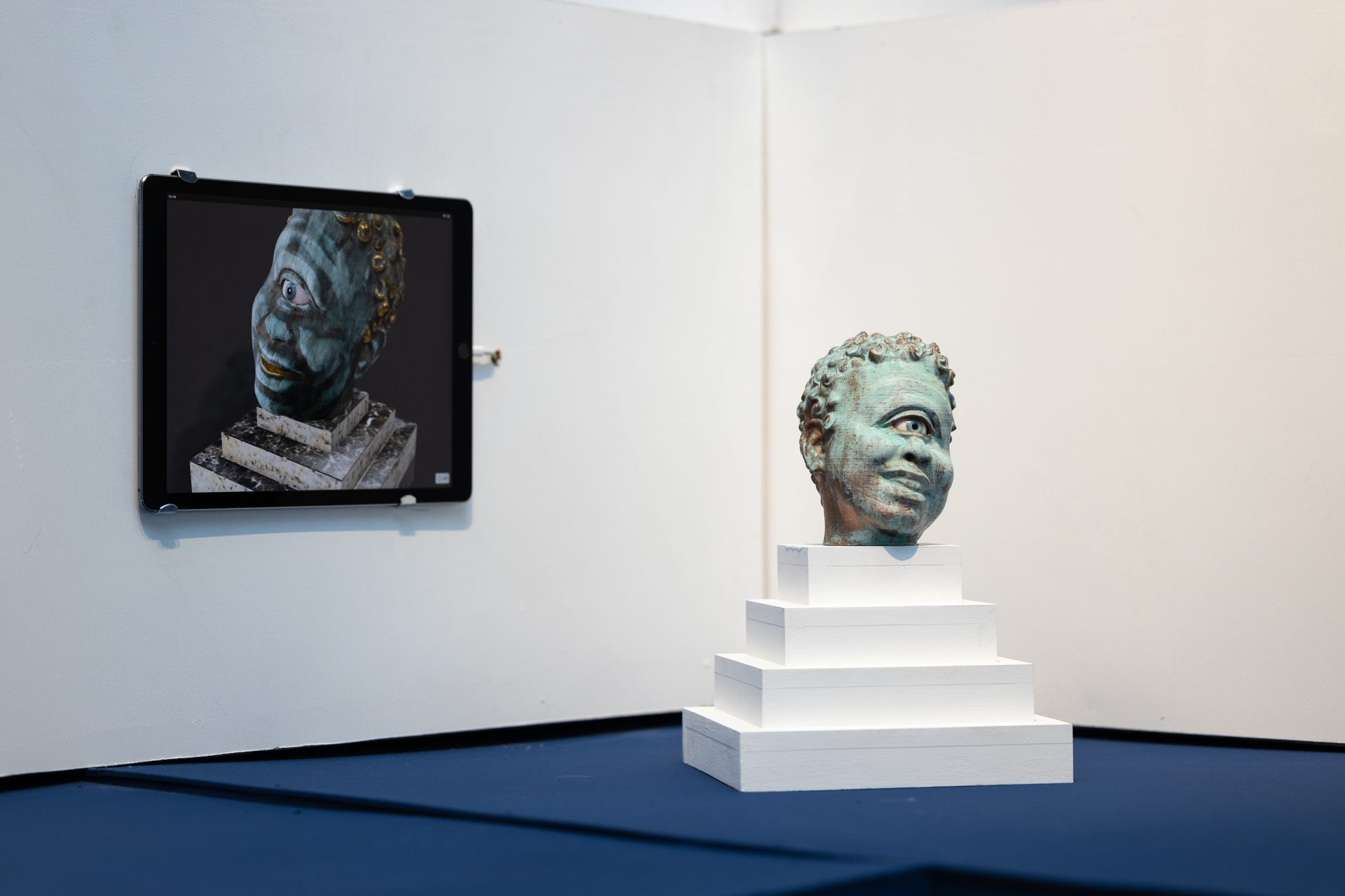 Auriea Harvey — teal Cyclops head beside iPad showing digital version, physical and digital side by side