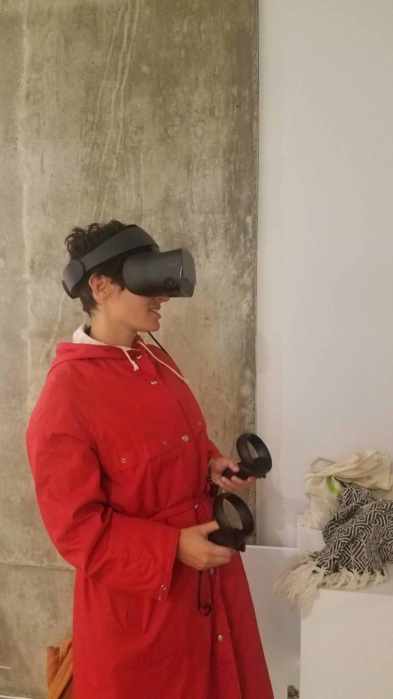 Visitor in red coat experiencing Political Archangels VR at ELLEPHANT Gallery