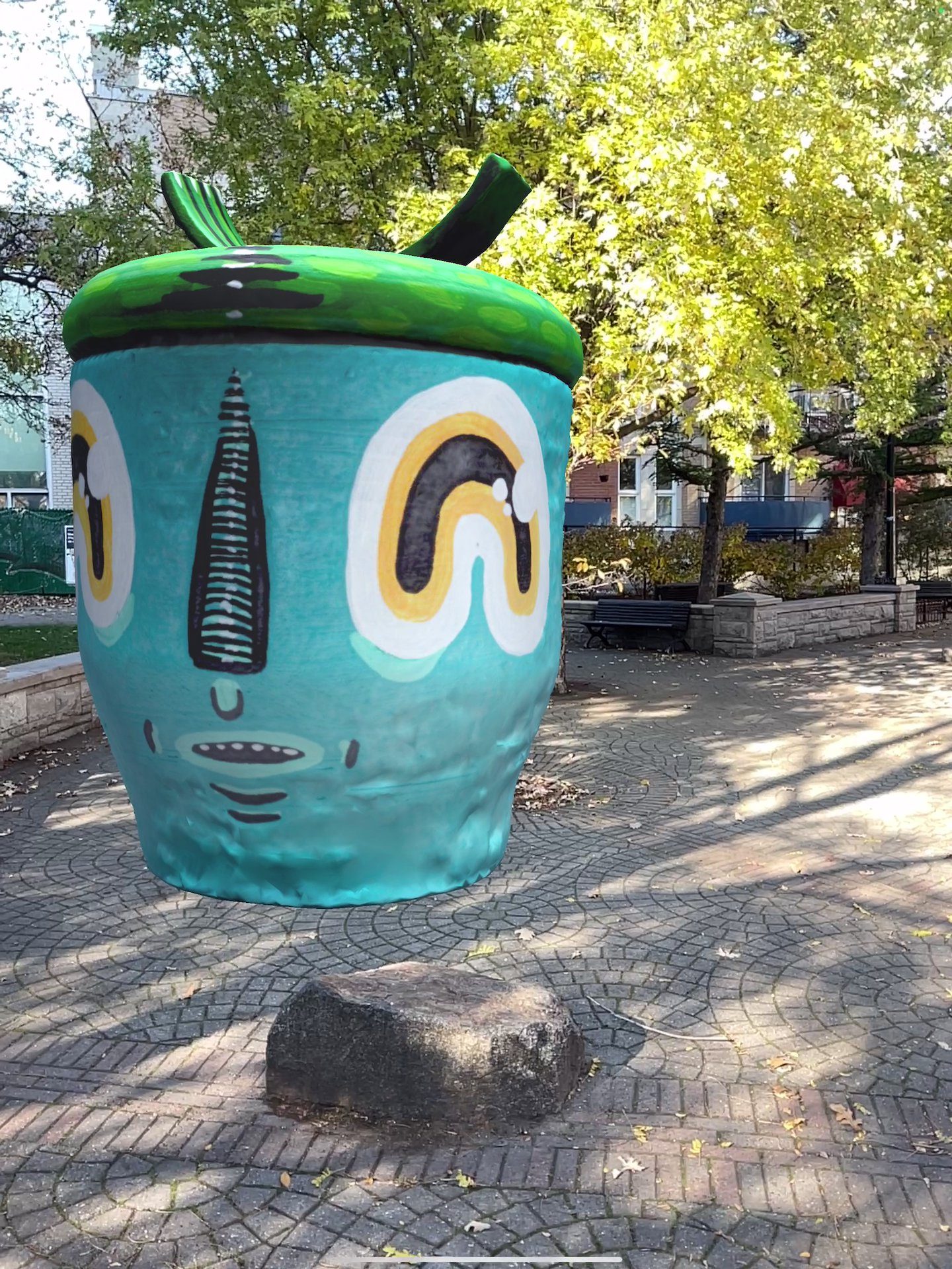 Waxhead's AR character — teal face with rainbow eyes and green apple top