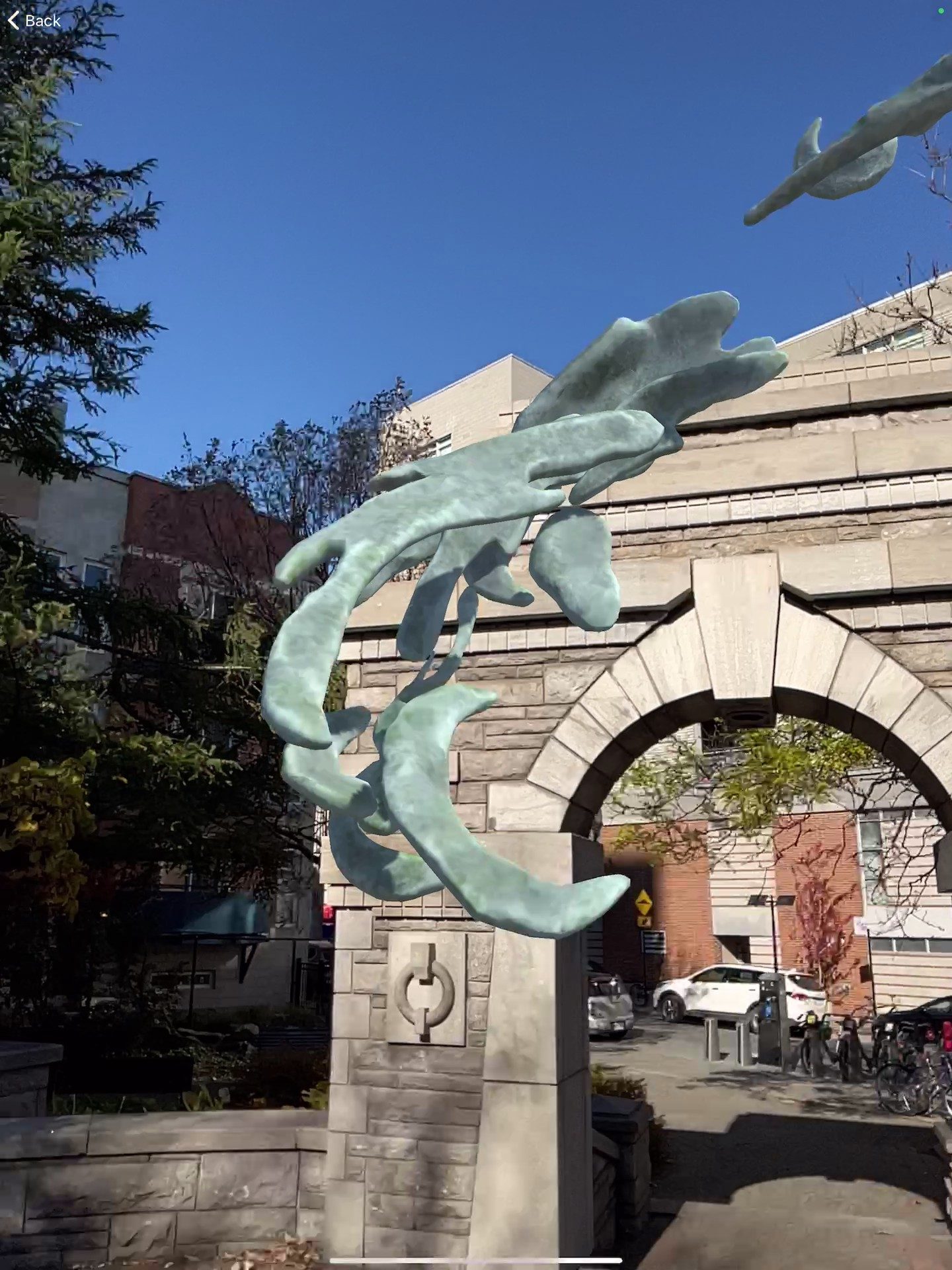 Samuel's AR sculpture — close-up detail of organic tendrils rising beside the arch pillar