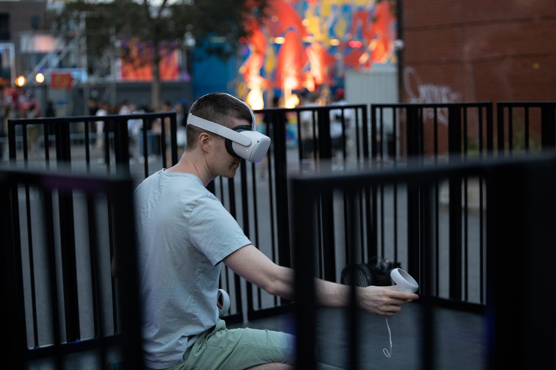 Samuel wearing VR headset with controllers, preparing to paint live at MURAL Festival