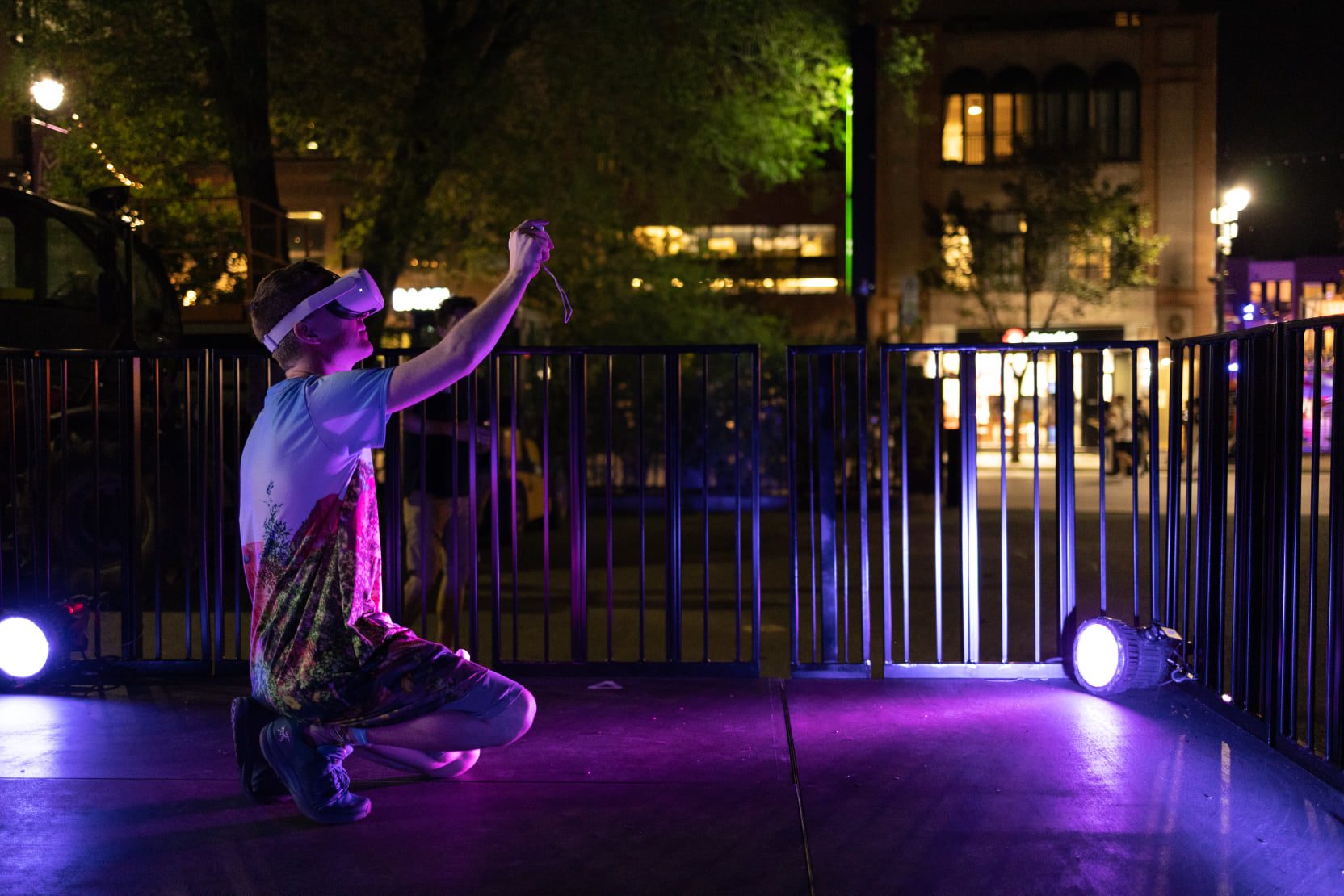 Samuel painting live in VR at MURAL Festival, purple stage lighting