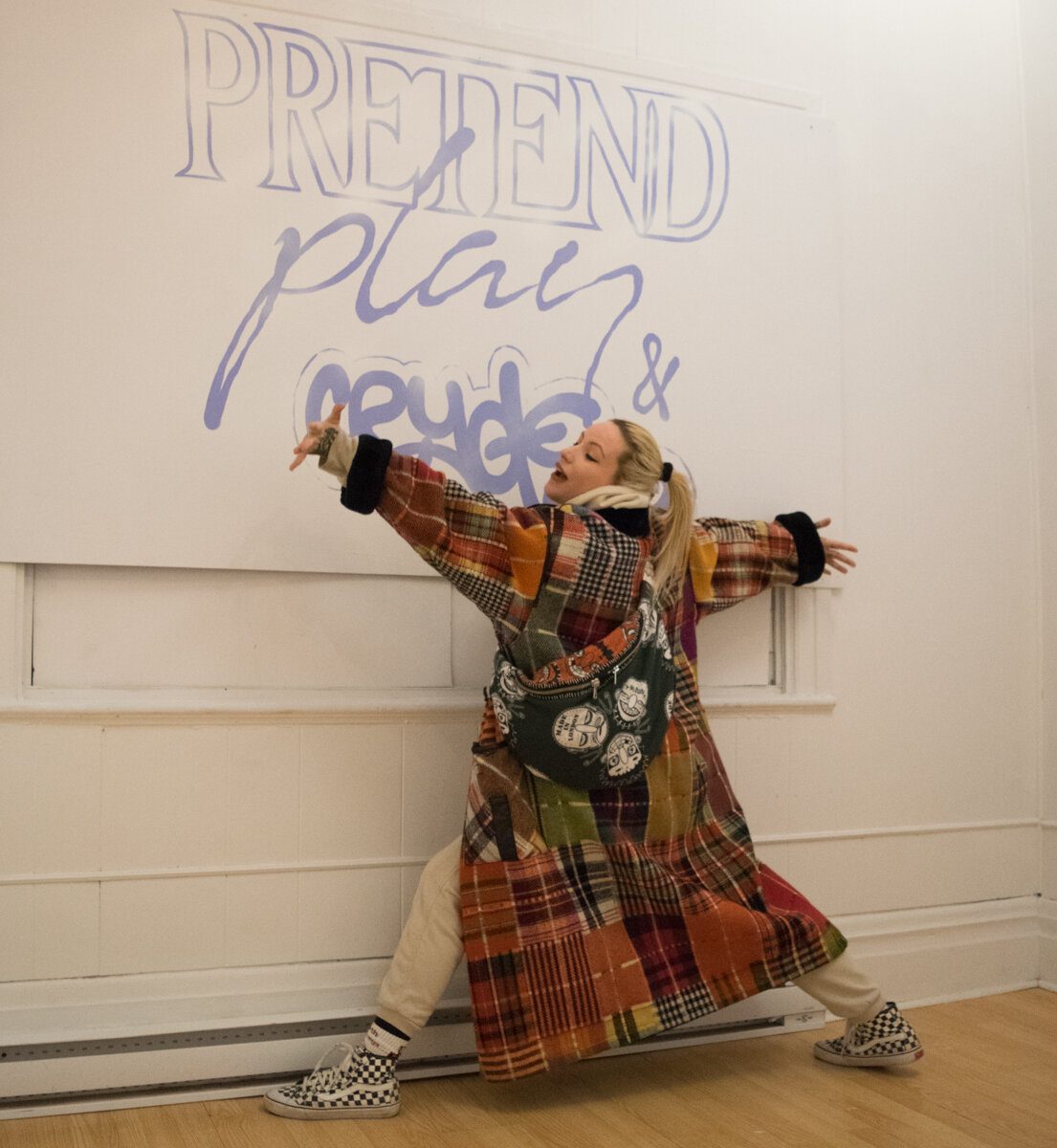 Pretend Play — gallery installation view with 'Pretend Play' text on the wall, fashion model figure visible