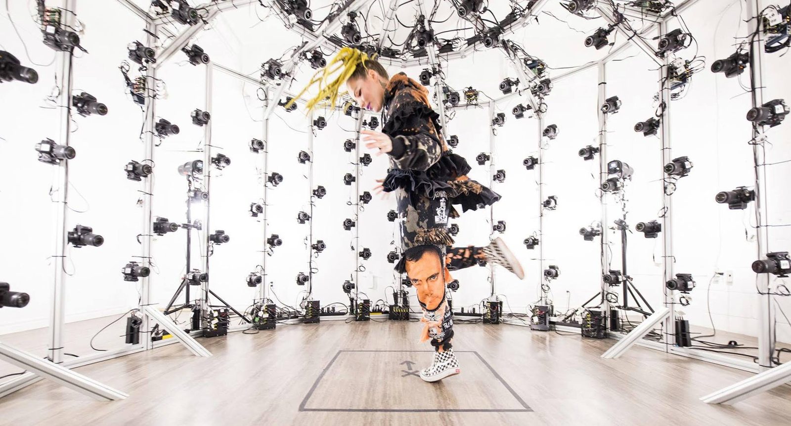 Pretend Play — fashion model against patterned backdrop with 3D scanned double visible, the physical and digital coexisting