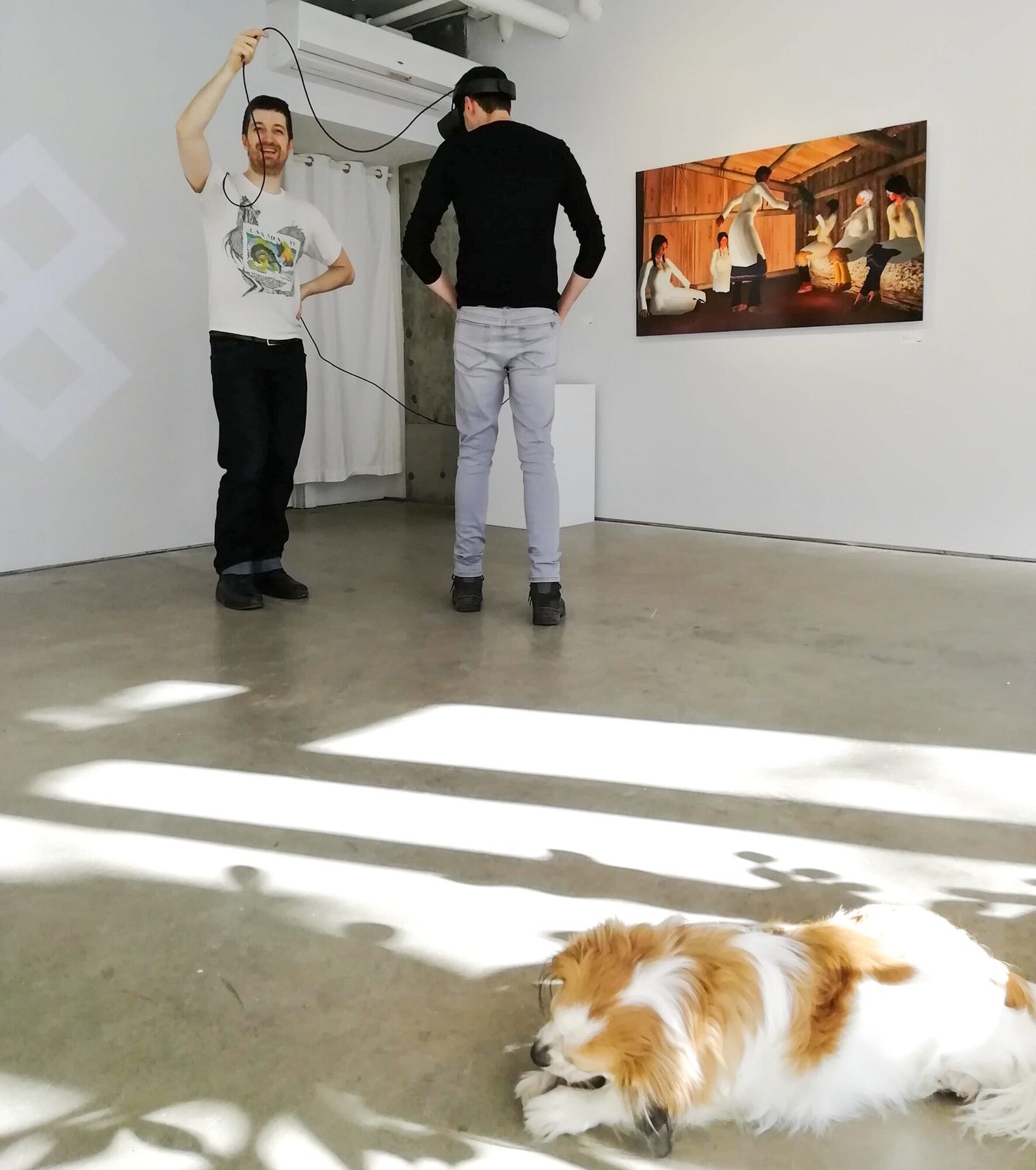 Salvo exhibition — the artist holding VR cable as visitor explores the virtual space